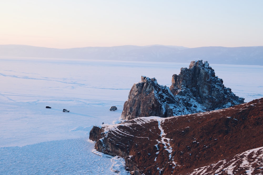 brown rock formation near body of water during daytime