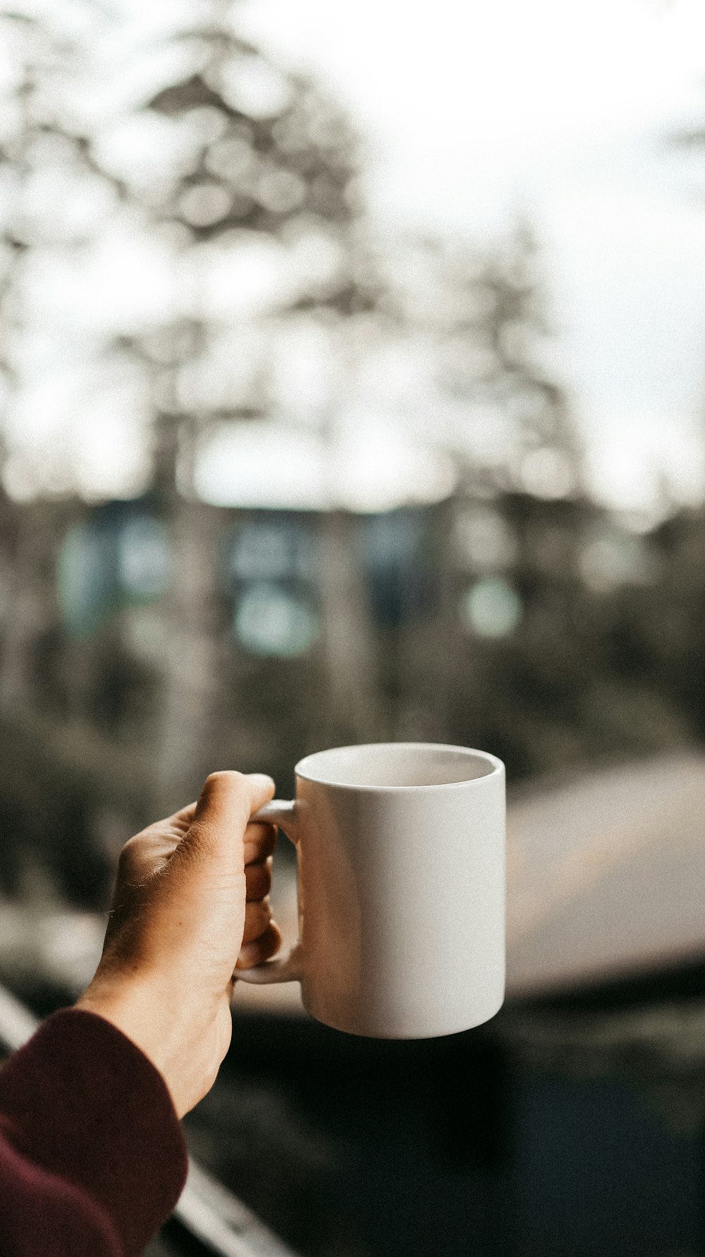 person holding white ceramic mug