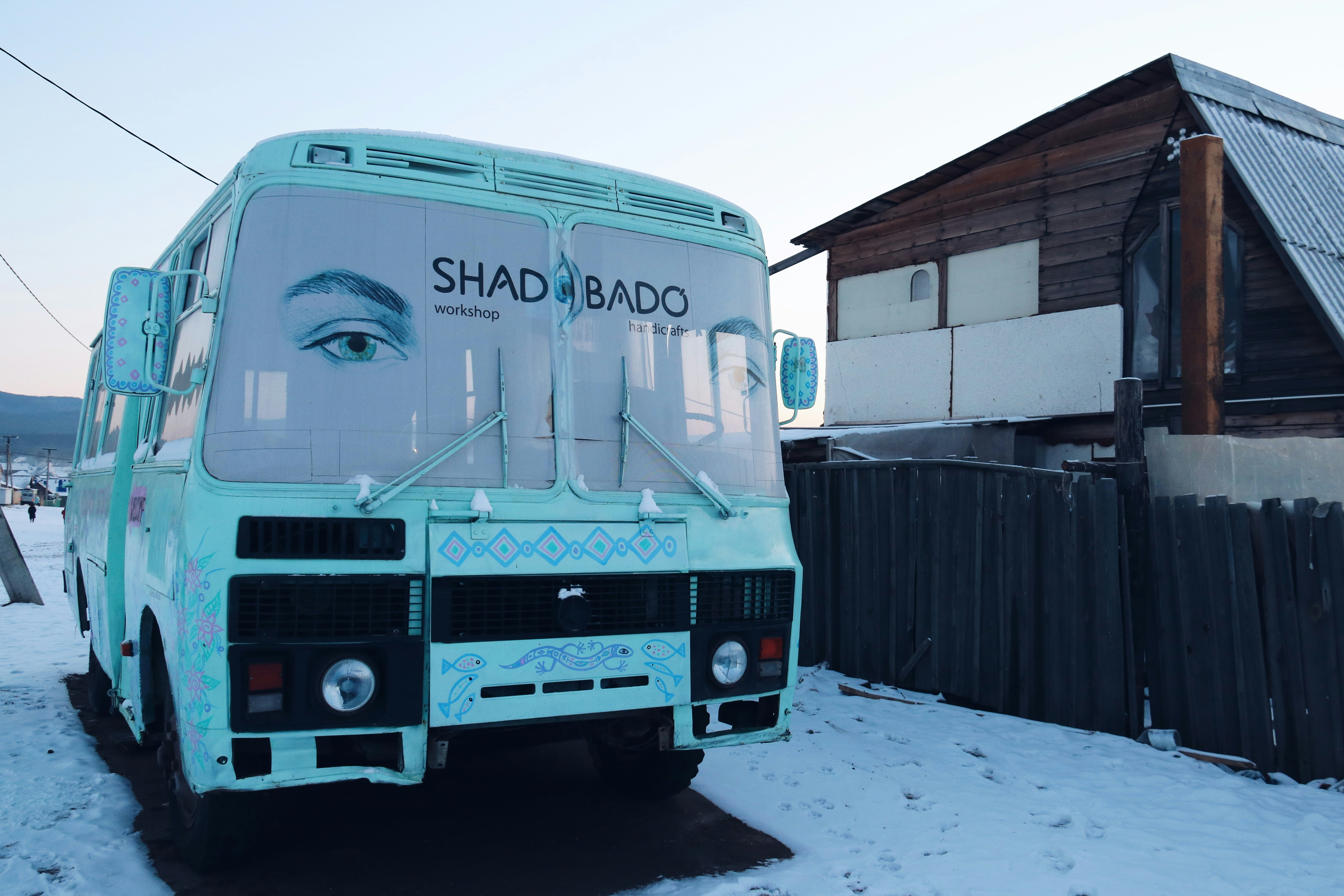 white and blue bus on road during daytime