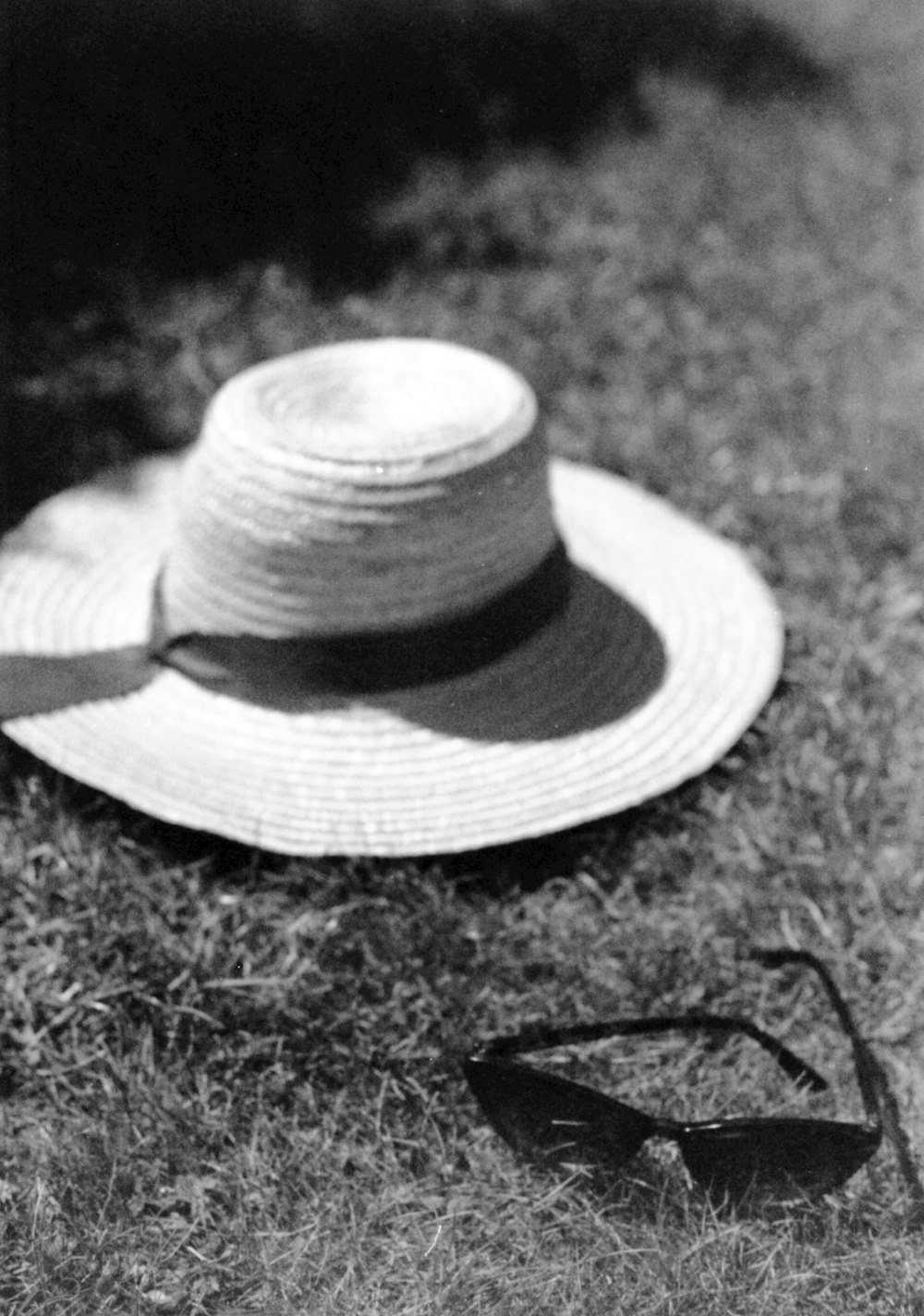 grayscale photo of fedora hat on grass