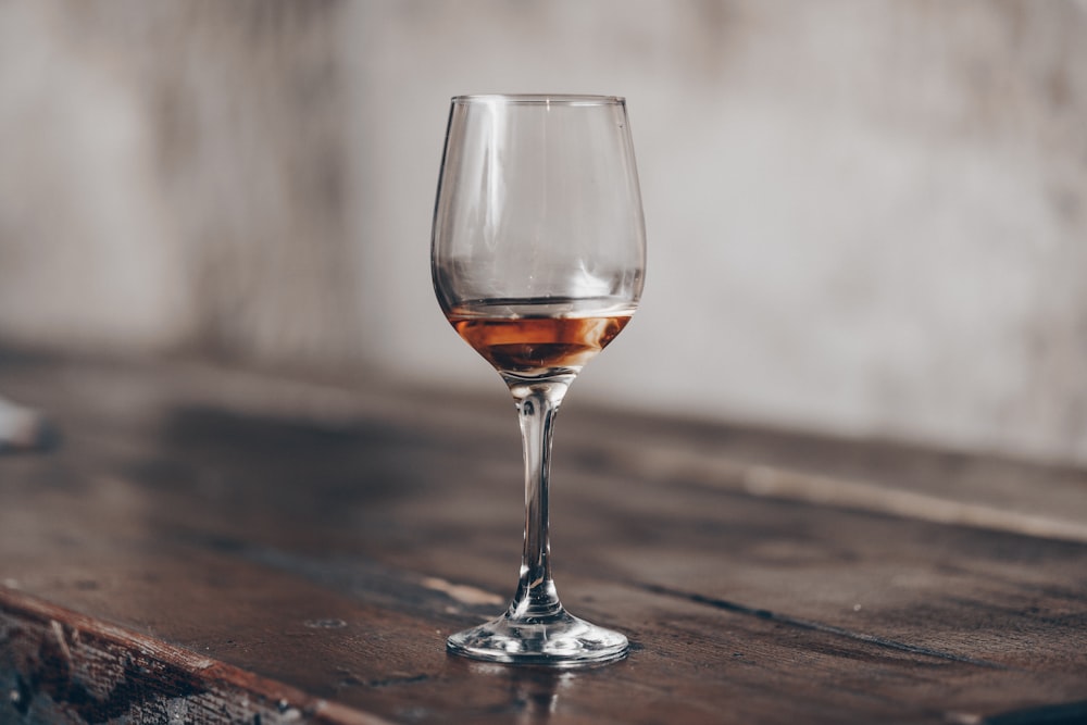 clear wine glass on brown wooden table