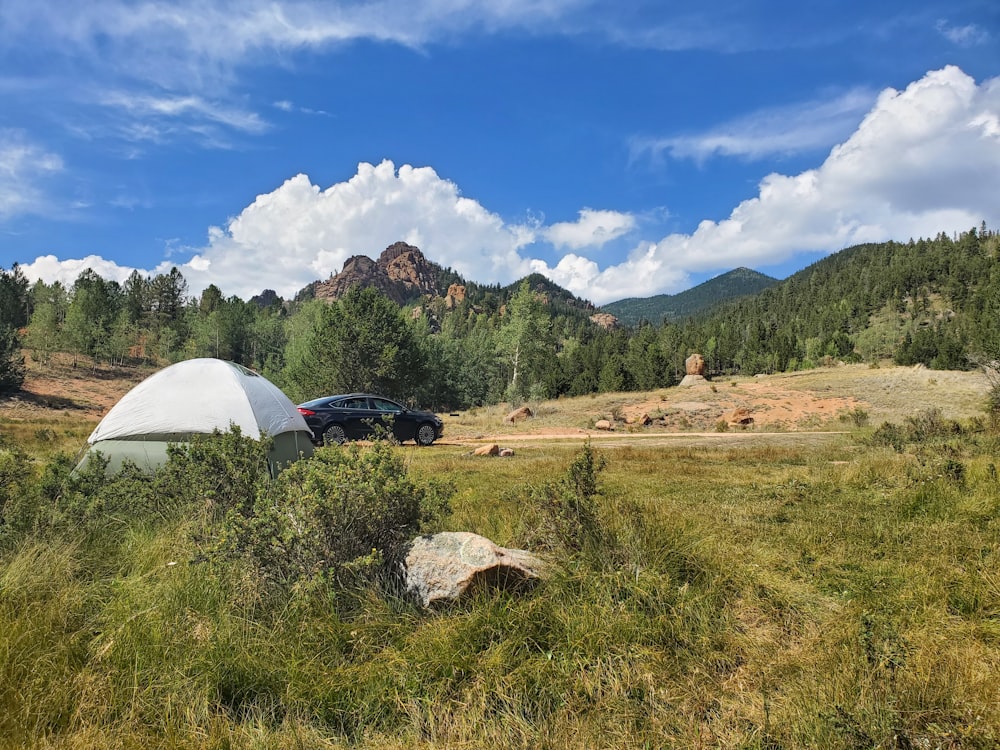 white dome tent on green grass field during daytime