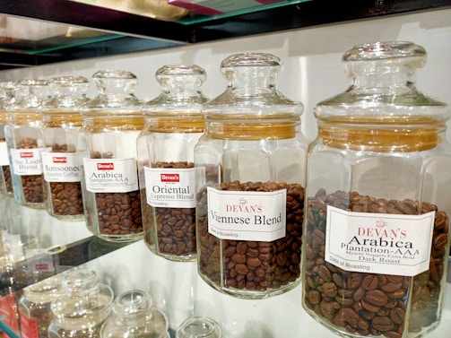 A variety of coffee beans displayed in jars.