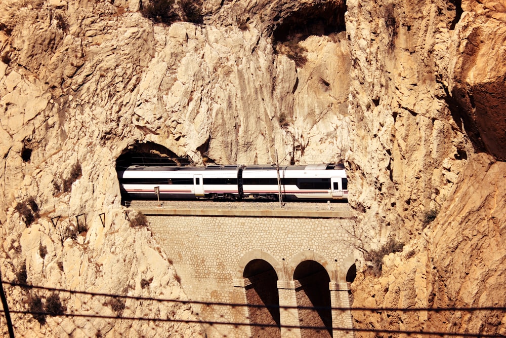 white and brown wooden ladder on brown rock formation