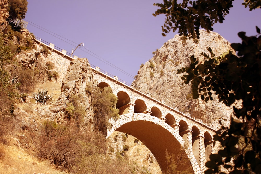 Puente de hormigón marrón bajo el cielo azul durante el día