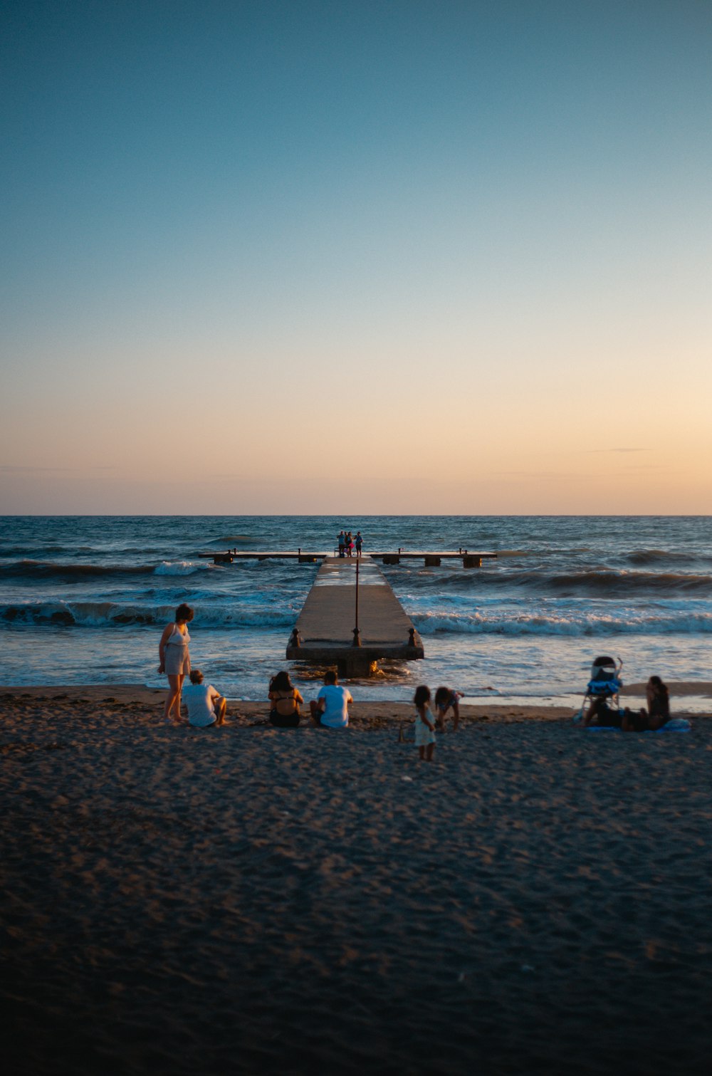 people on beach during sunset