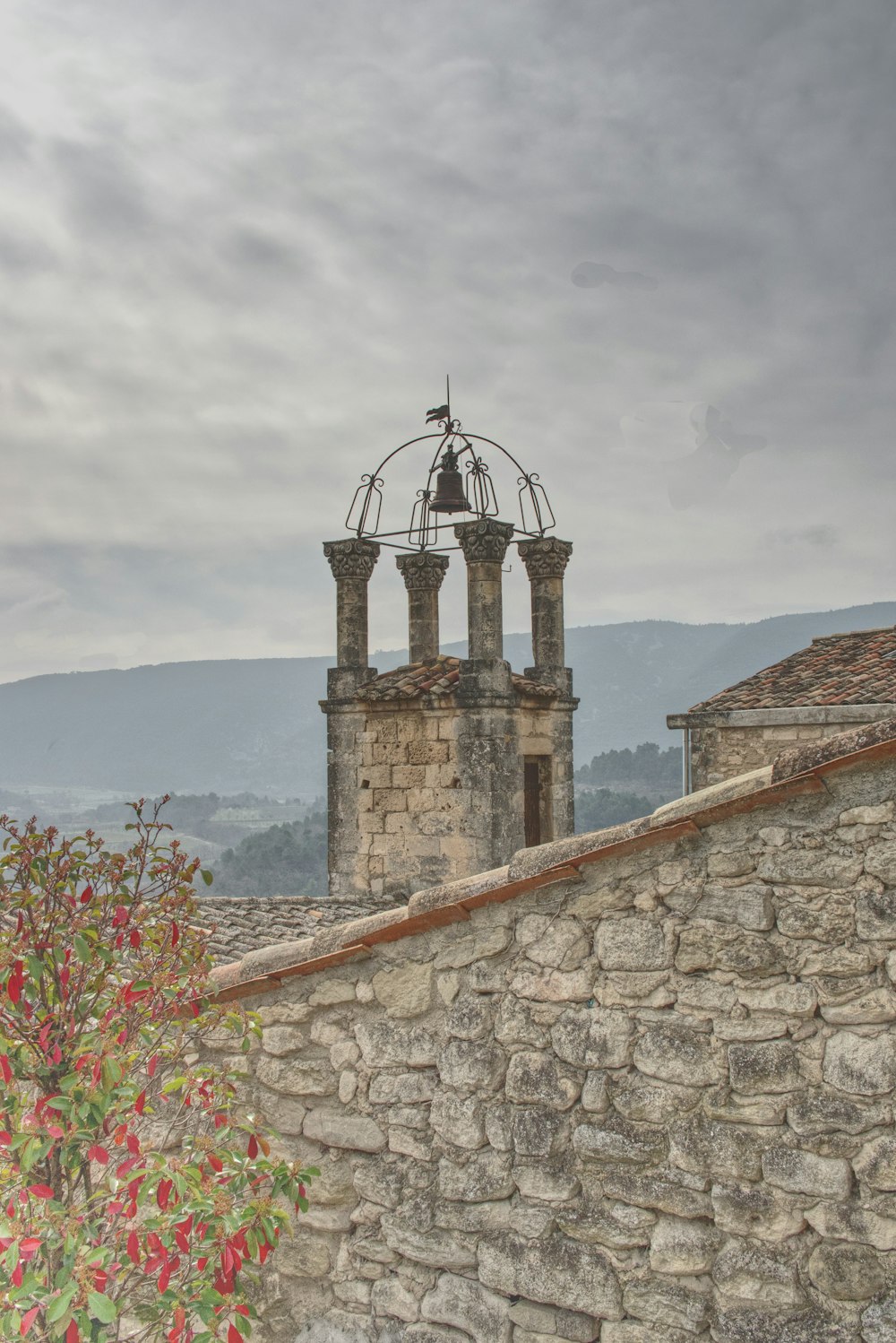 brown brick building near mountain under white clouds during daytime