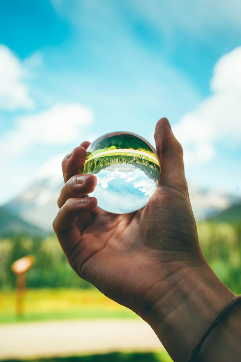 person holding clear glass ball