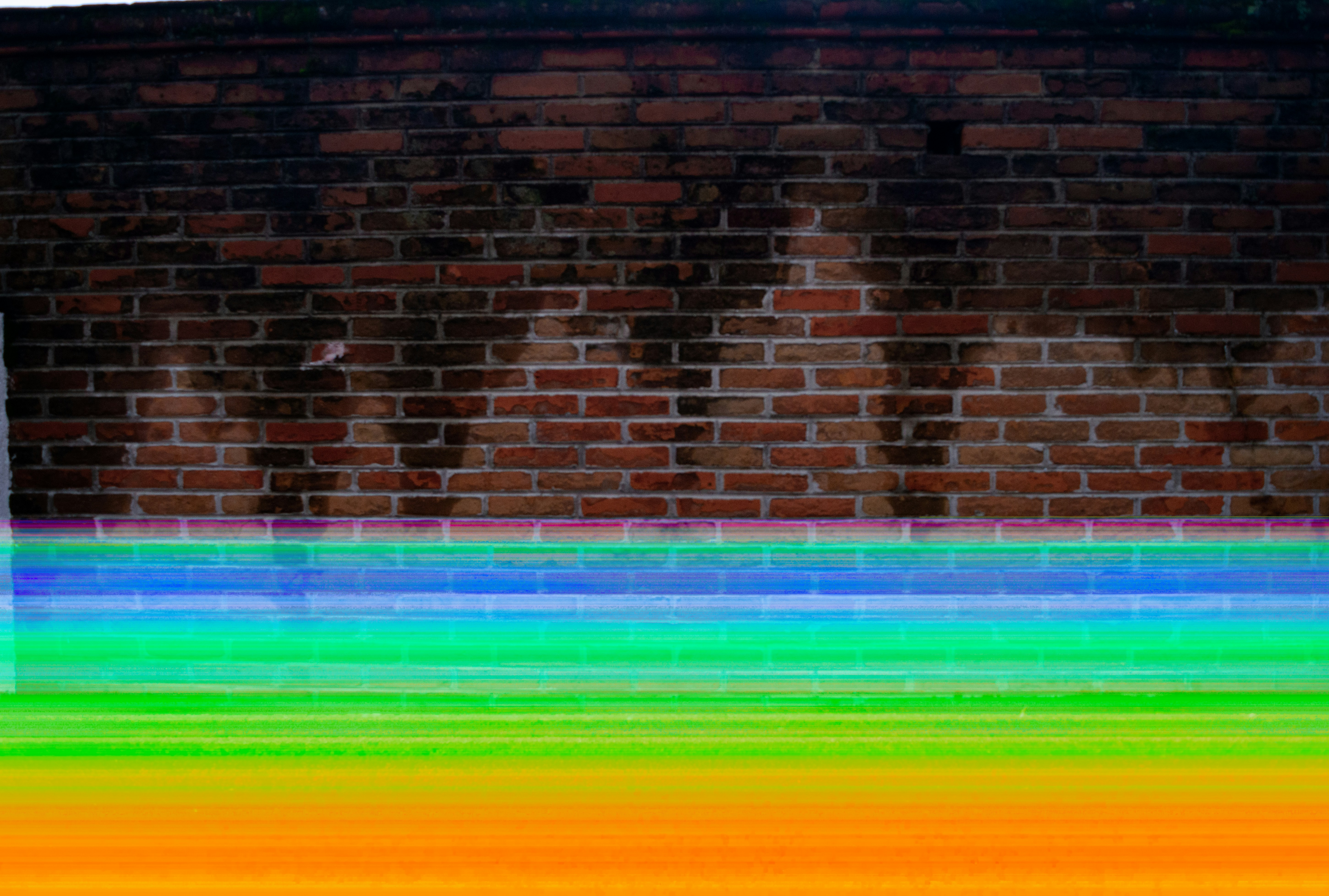 brown brick wall with multi color lights