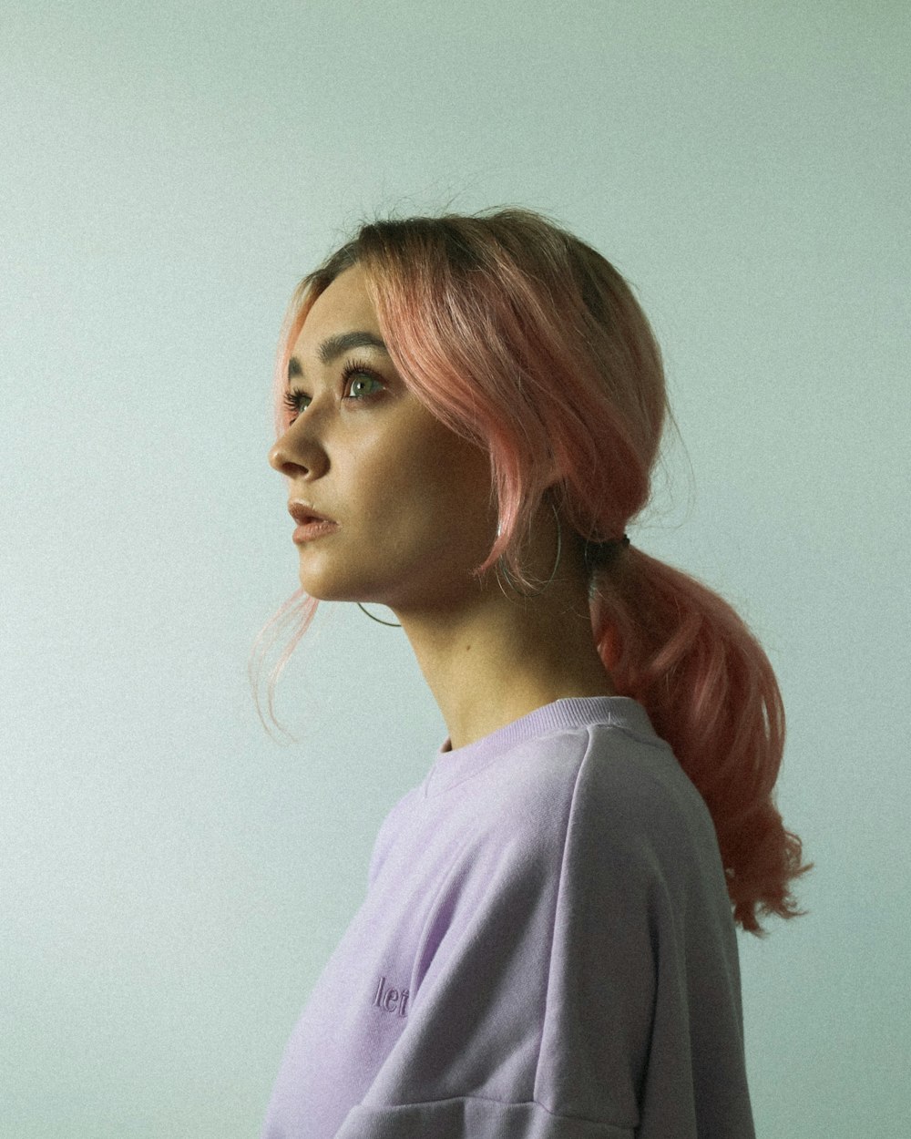 woman in pink hair wearing white shirt