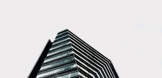 A sleek, modern warehouse with navy blue and steel grey accents under a bright sky.