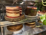 A rustic cake display featuring a variety of artisan cakes.