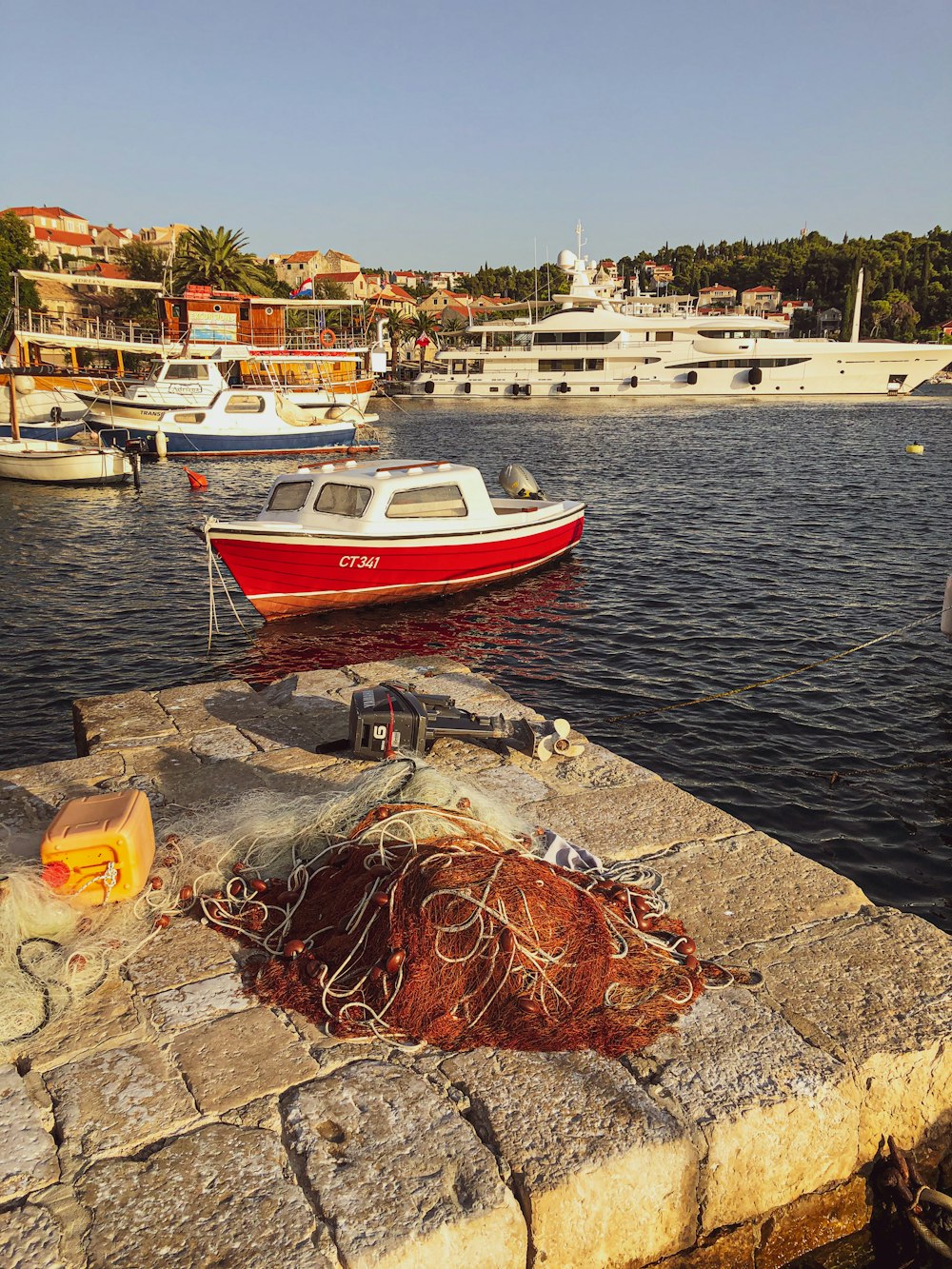 red and white boat on dock during daytime