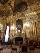 people sitting on red chairs inside building