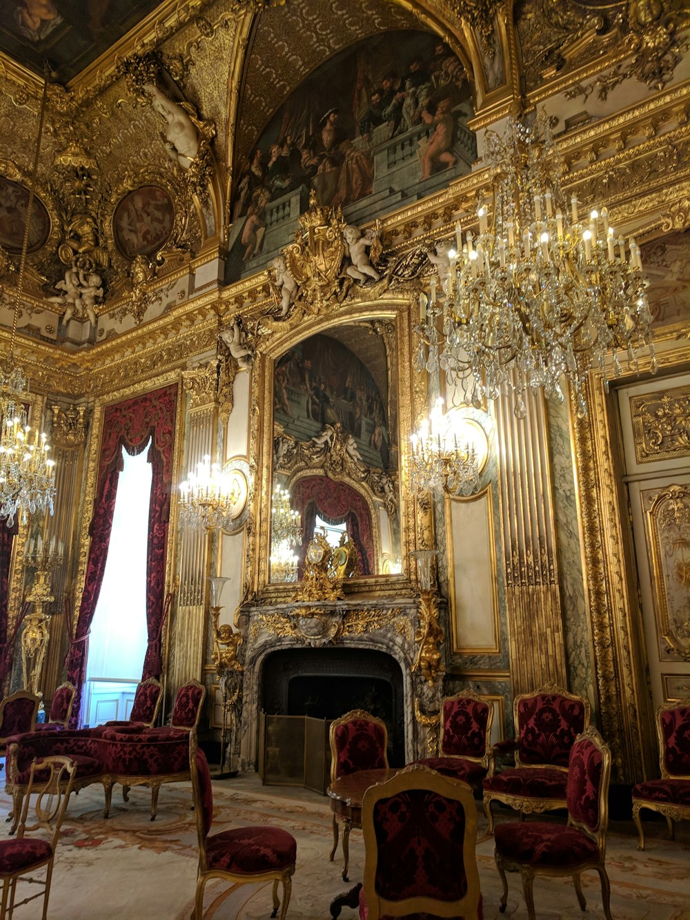 people sitting on red chairs inside building