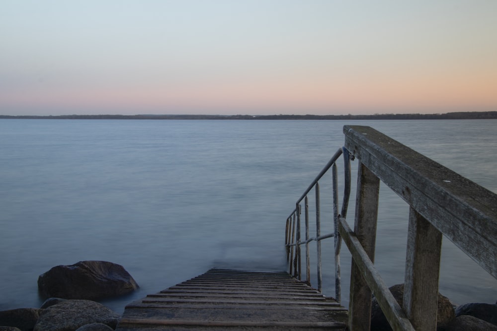 brown wooden dock on blue sea during daytime