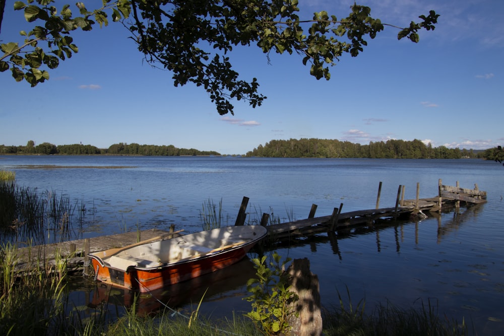 brown wooden boat on body of water during daytime