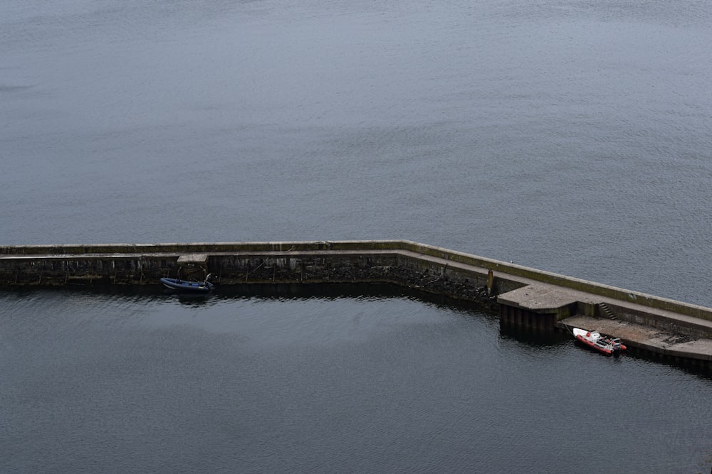 brown wooden dock on body of water during daytime