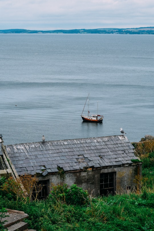 brown and black boat on sea during daytime in Inchkeith United Kingdom