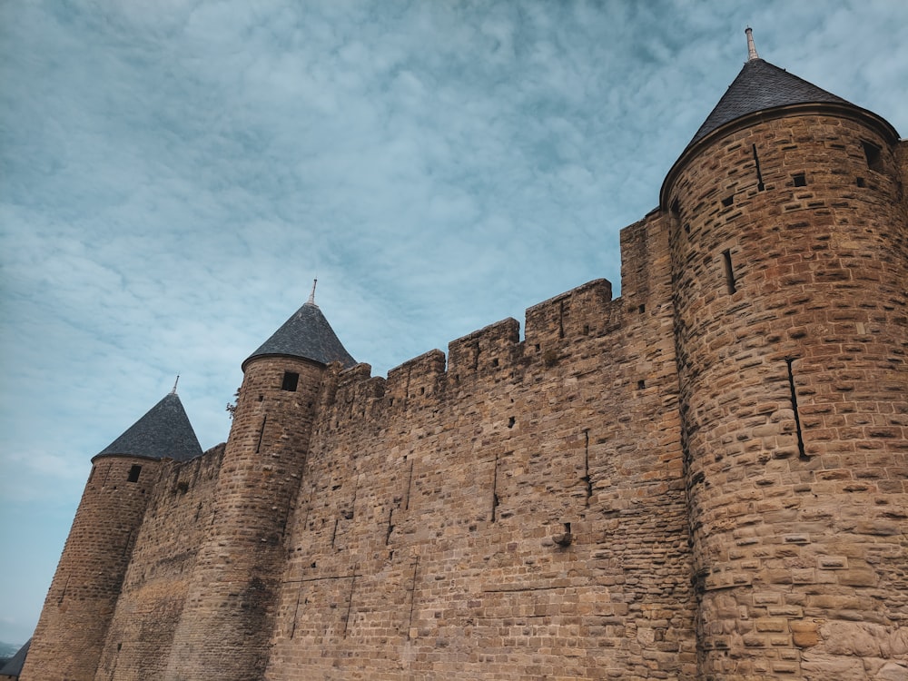 brown brick castle under blue sky during daytime