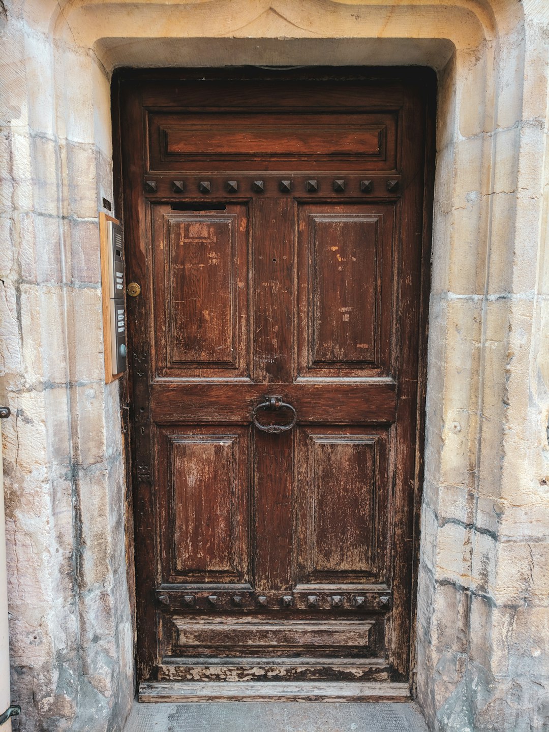 brown wooden door on white concrete wall