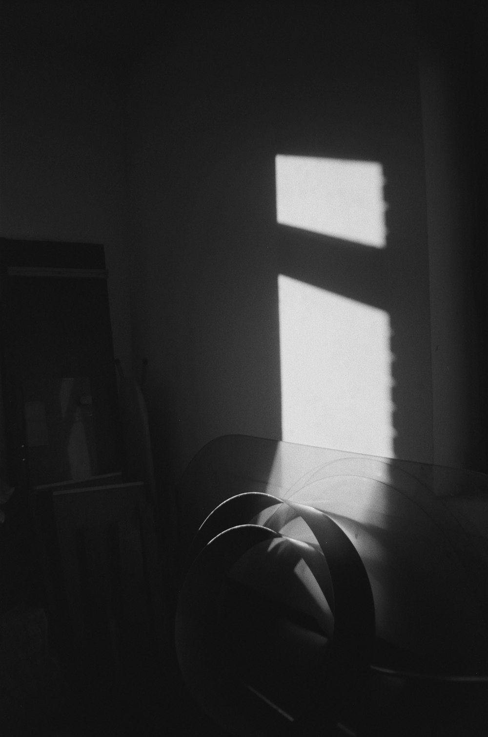 grayscale photo of window with curtain