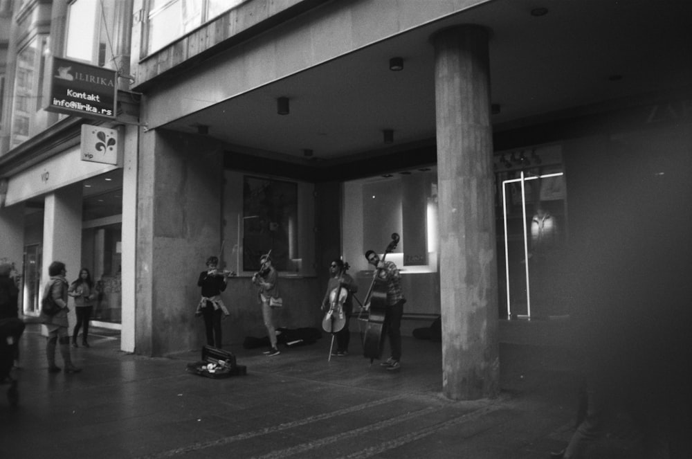 grayscale photo of people walking on hallway