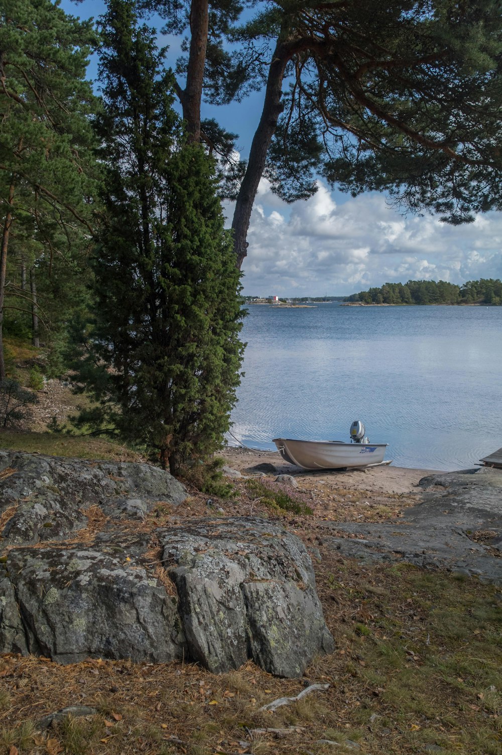 person riding on white boat on lake during daytime