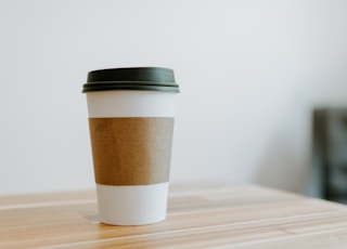 white and brown paper cup