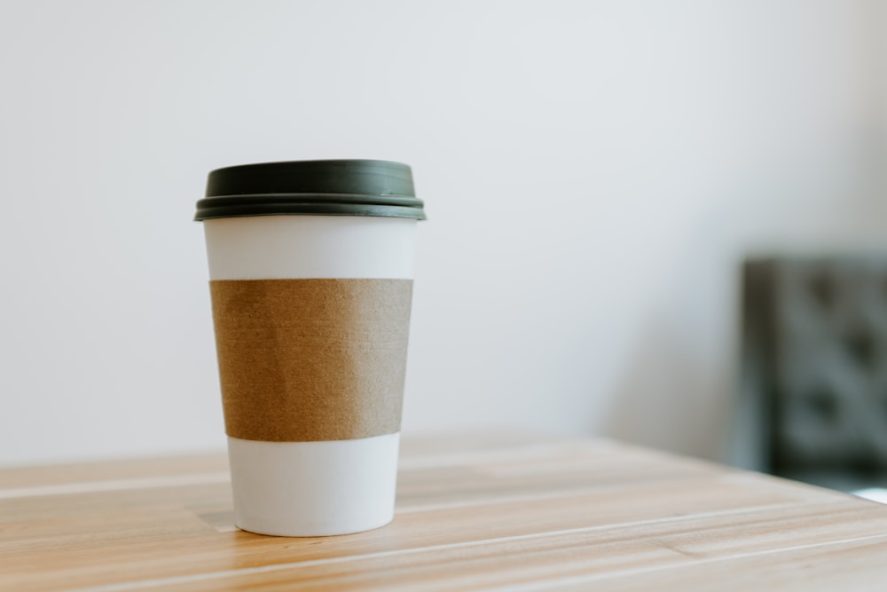 white and brown paper cup