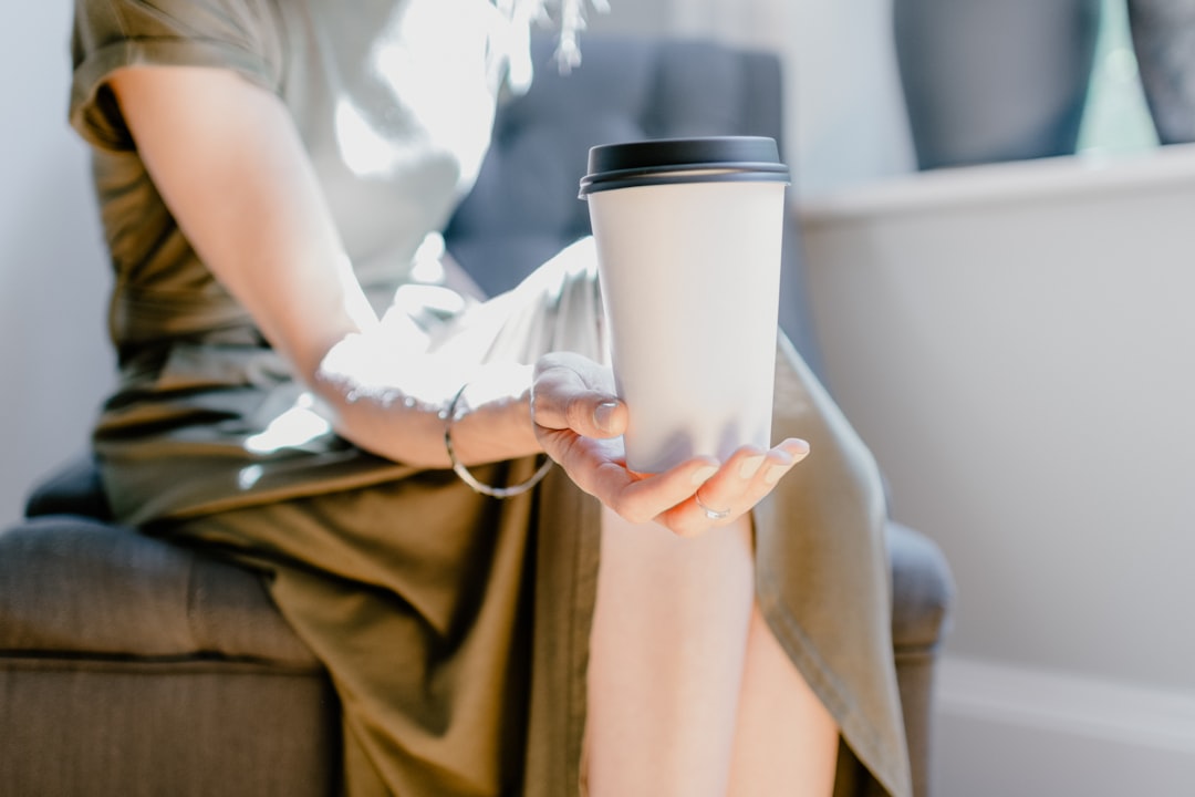 person holding white ceramic mug