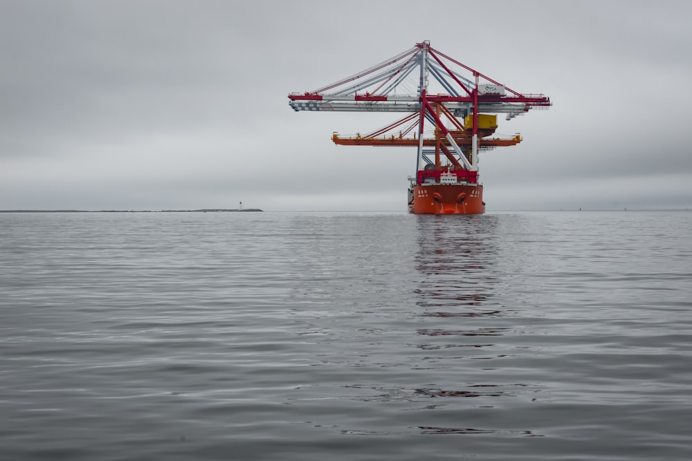 red and black ship on sea during daytime