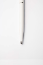 white pen on white surface