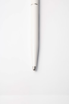 white pen on white surface