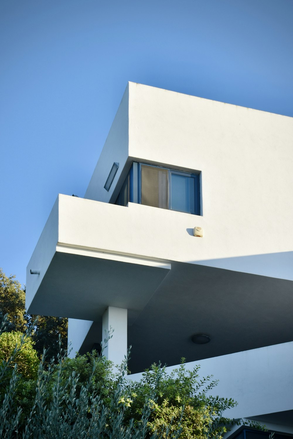 white concrete building with blue window