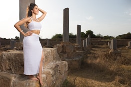 Lara Croft cosplay standing on ancient ruins at sunset, evoking a sense of adventure.