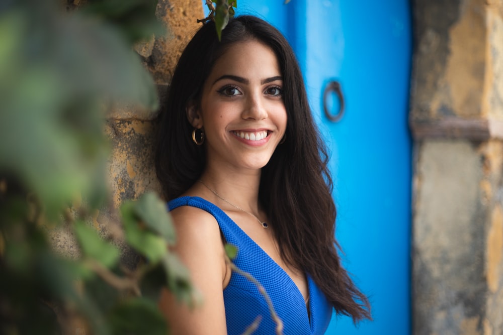 woman in blue tank top smiling