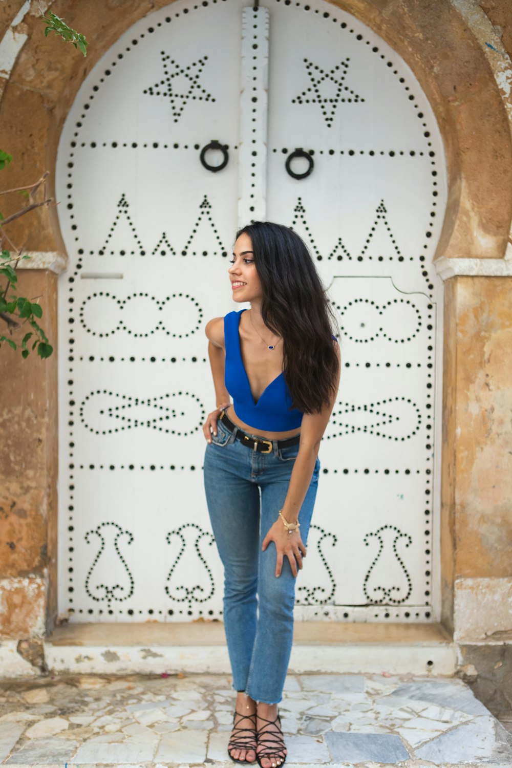 woman in blue tank top and blue denim jeans