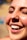 A close-up of a satisfied customer smiling at their new website.