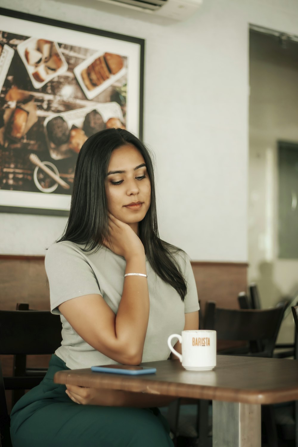 woman in white t-shirt sitting on chair