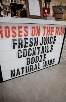 a sign that says roses on the run fresh juice cocktails booze natural wine