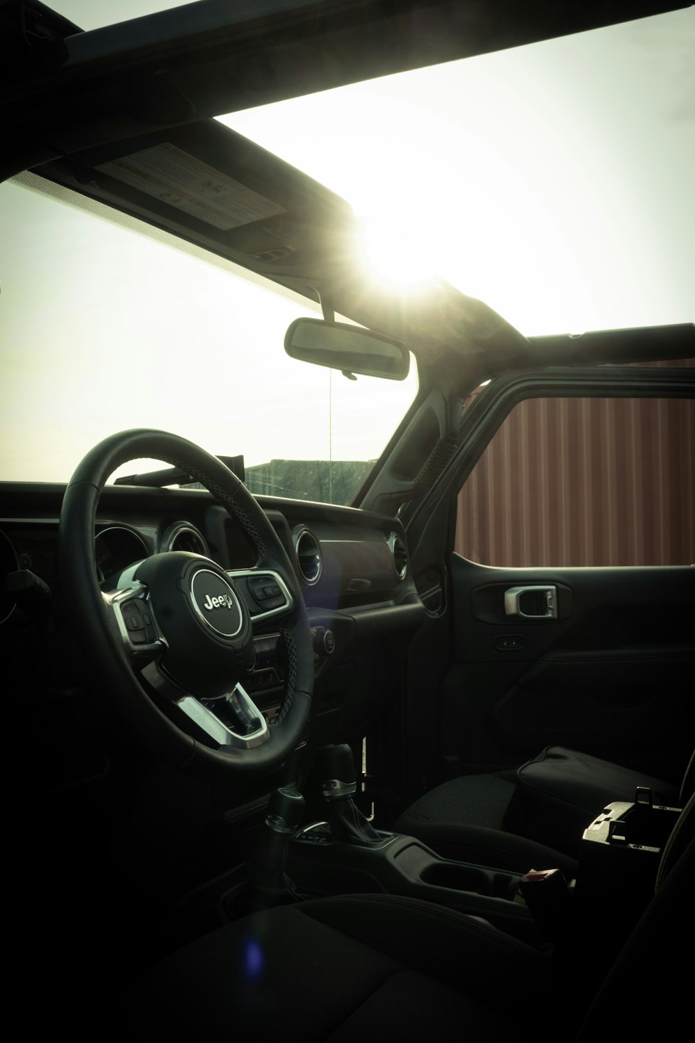 black car steering wheel during daytime
