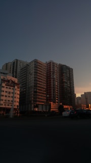 A panoramic shot of a Dream Nest Developer apartment complex at sunset, highlighting the modern architecture.
