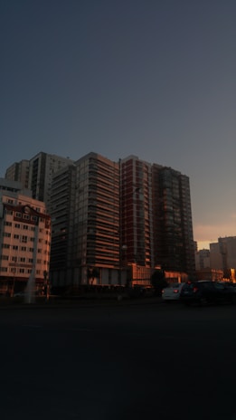 A panoramic shot of a Dream Nest Developer apartment complex at sunset, highlighting the modern architecture.