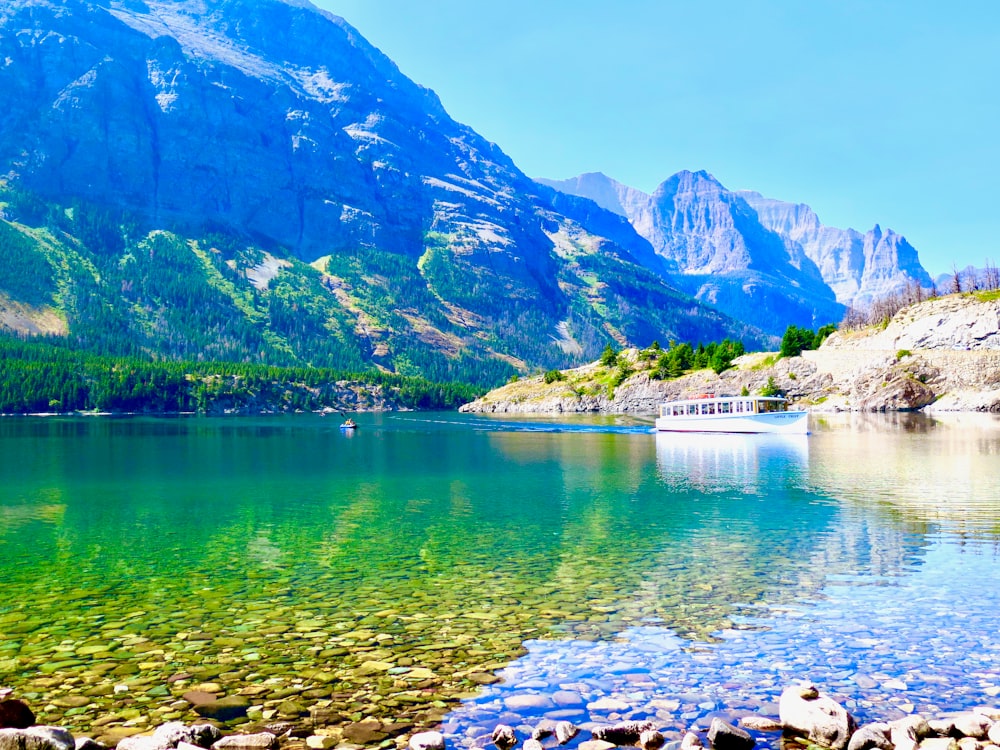 green and brown mountain beside body of water during daytime