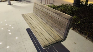A DIY wooden bench made from kereste with elegant, clean lines placed in a garden.