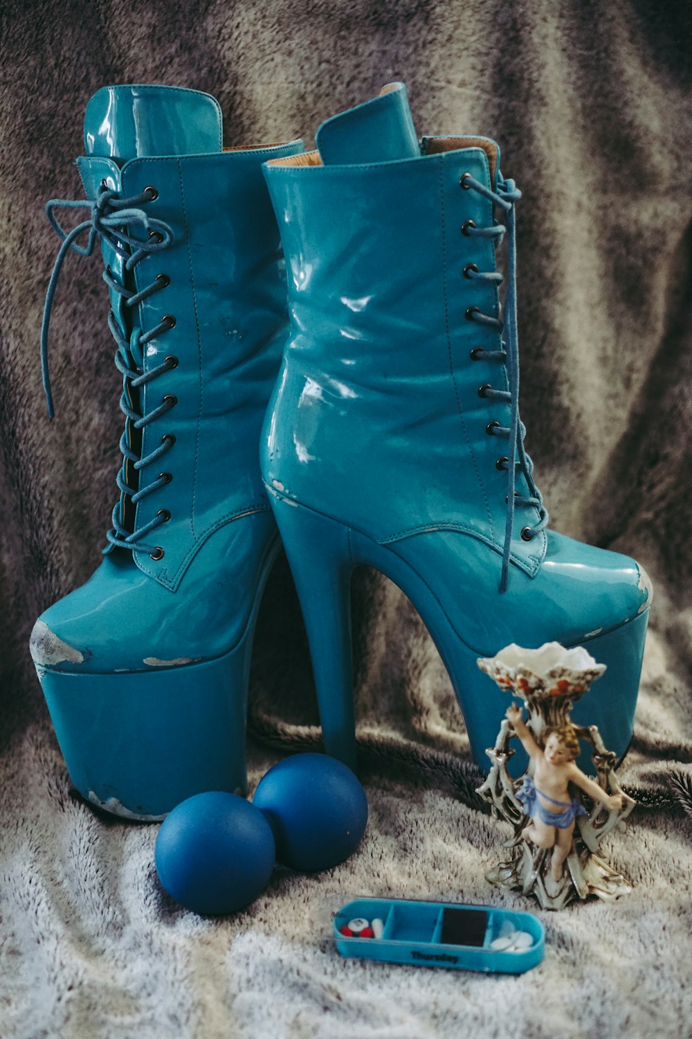 blue leather boots on brown textile