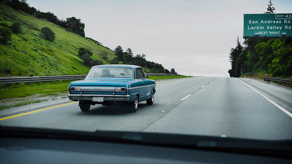 blue car on road during daytime