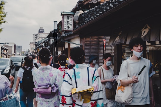 people in white uniform standing near brown wooden building during daytime in Kawagoe Japan