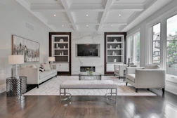 white wooden coffee table near white sofa